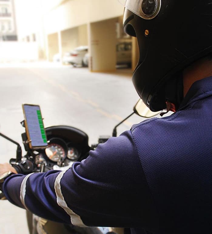 Tawseel rider checking a delivery on his phone